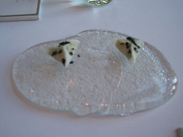 louise_03.JPG - SNACK NUMBER 3 - UNFORTUNATELY, THIS PICTURE CAME OUT BLURRED, HOWEVER IT WAS A VERY TASTY DISH OF 2 TINY RAVIOLI CREPES, WITH A DELICIOUS CRAB FILLING. IT WAS SERVED ON A SLAB OF GLASS.