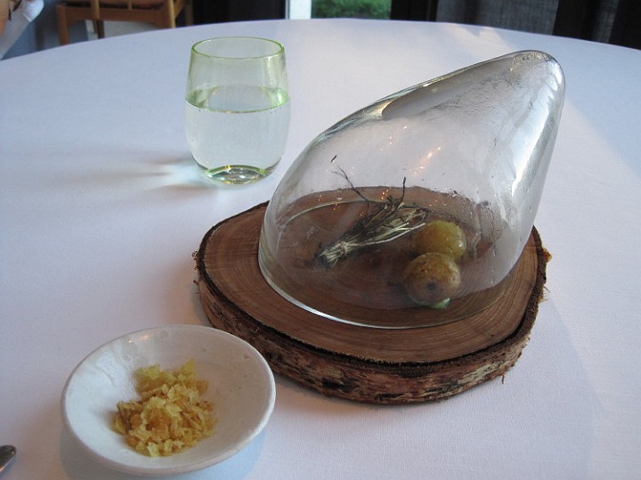 louise_04.JPG - SNACK NUMBER 4 - THIS LOOKS LIKE A SIMPLE DISH, BUT IT WAS ACTUALLY ONE OF THE MOST INTERESTING - 2 DANISH POTATOES UNDER A GLASS BELL, WITH A PACKET OF HERBS WHICH WAS LIT ON FIRE TO CREATE SMOKE AND WHICH SMOKED THE POTATOES.  SIMPLE, BUT DELICIOUS.